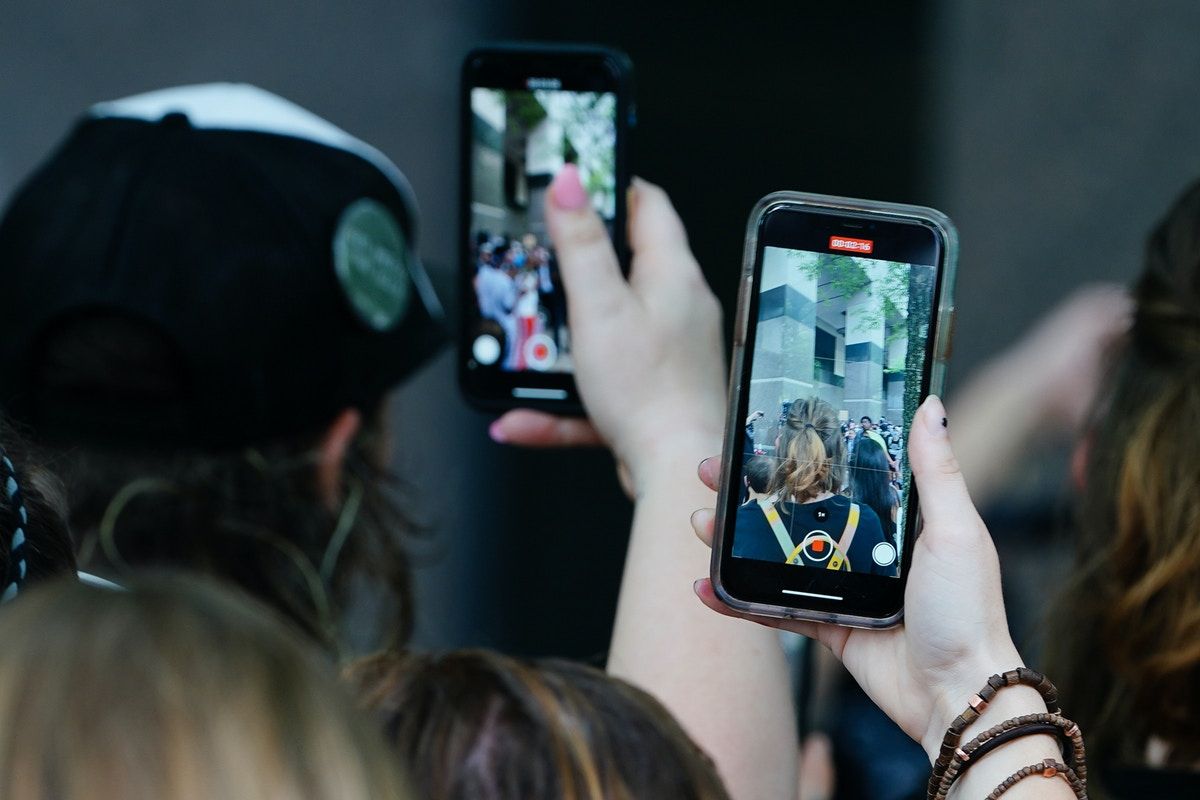 Picture shows people using their phones to film protests