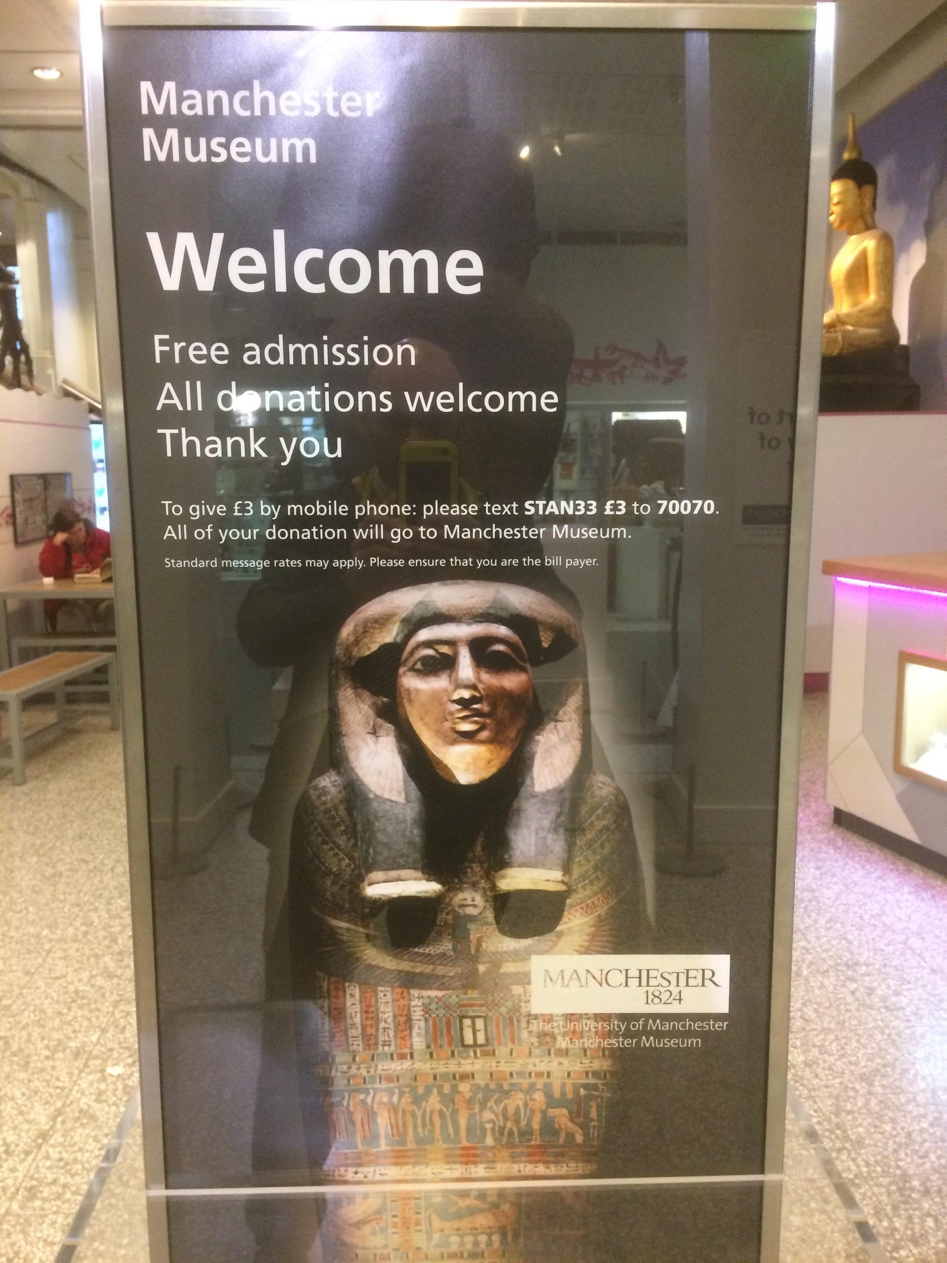 A museum placard invites people into the museum for free.