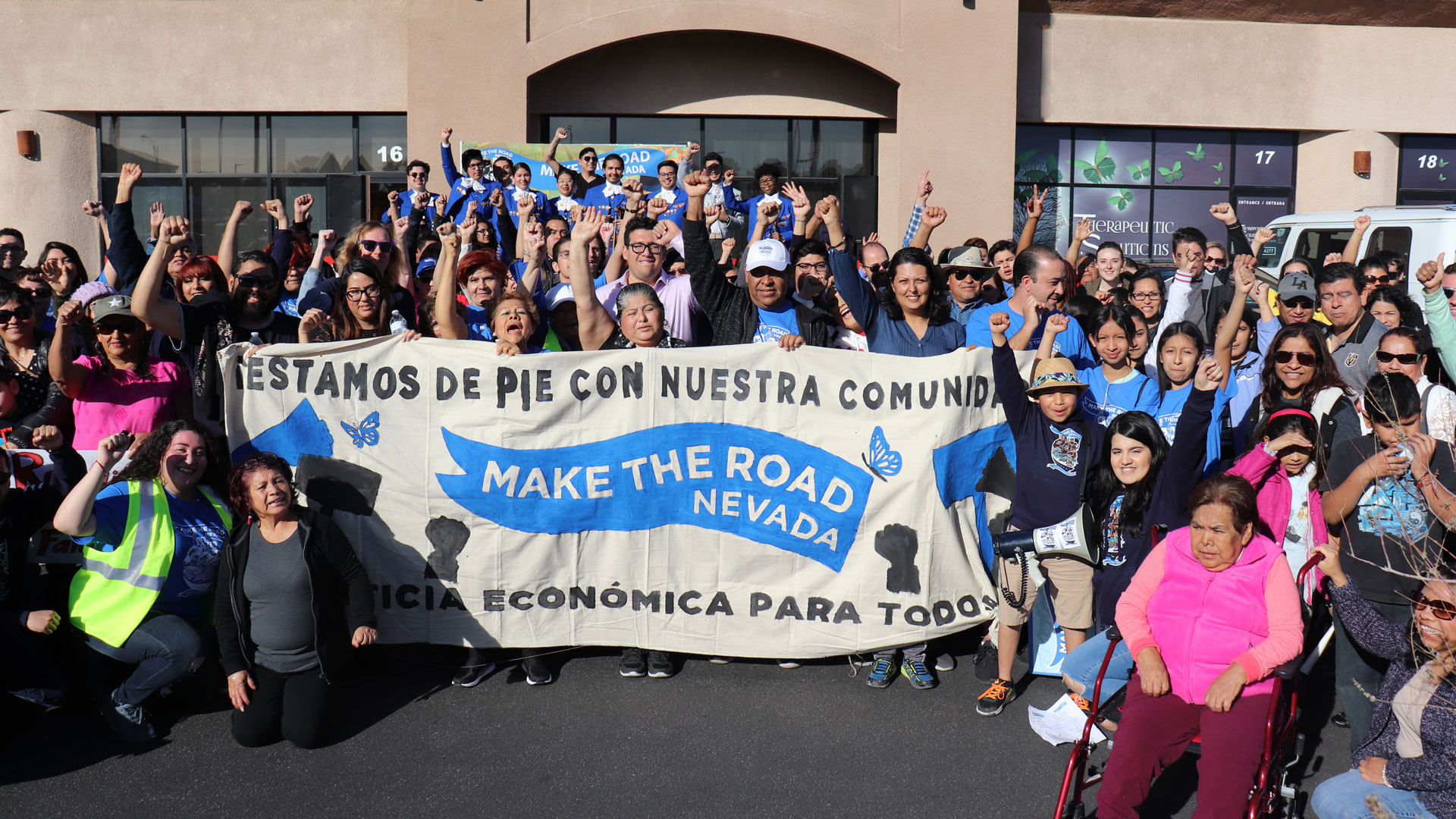 Make the Road Nevada staff members pose for a photo holding a banner in spanish