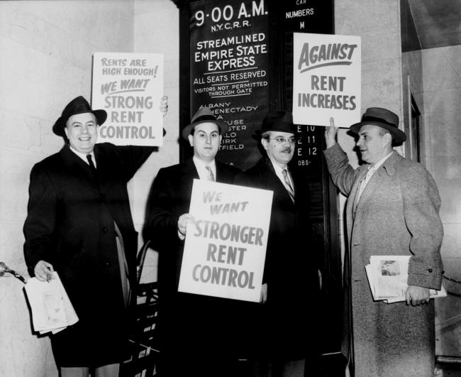 black and white photo of people holing placards