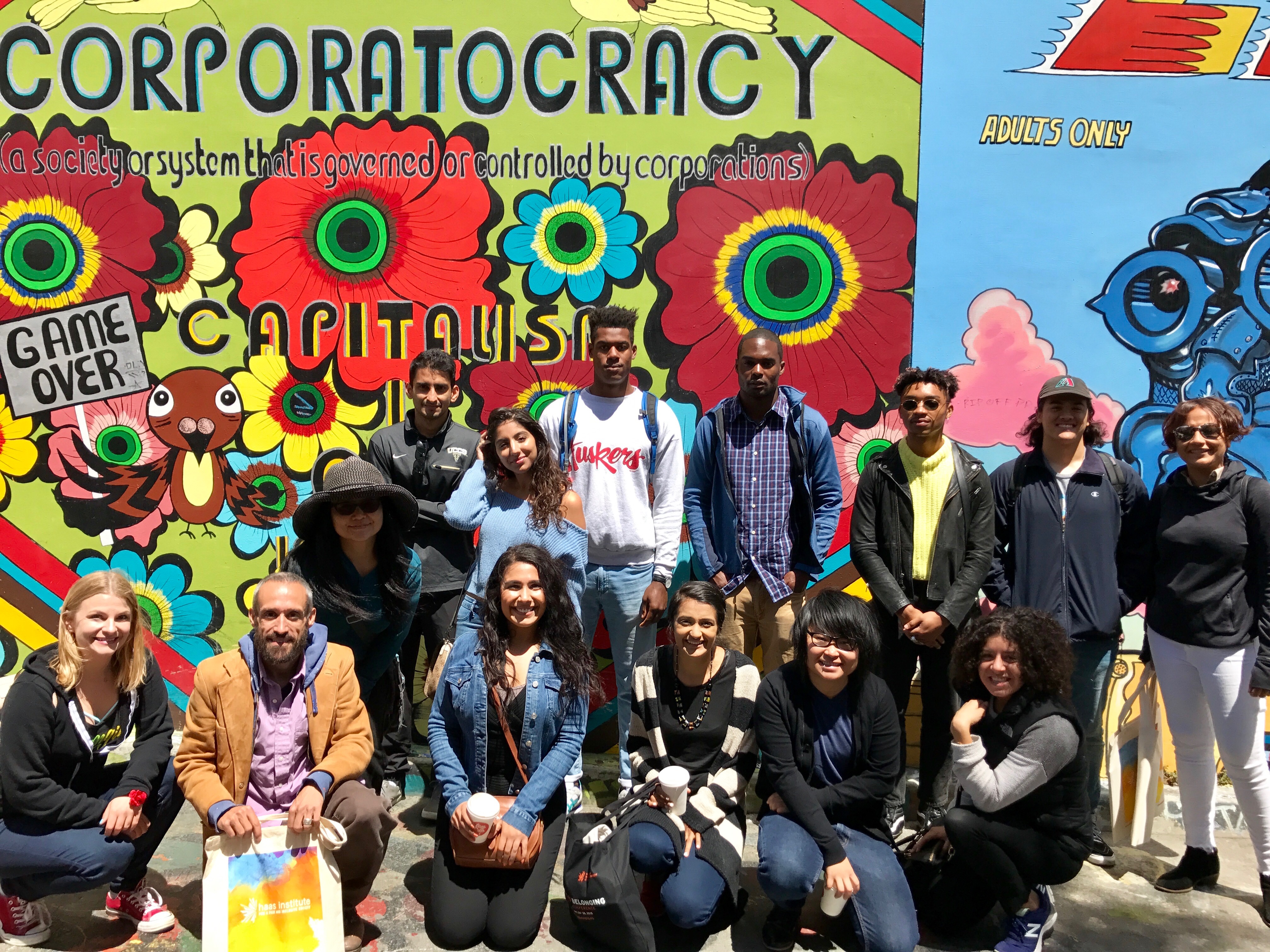 2017 Summer fellows pose in front of a mural in San Francisco's Mission District