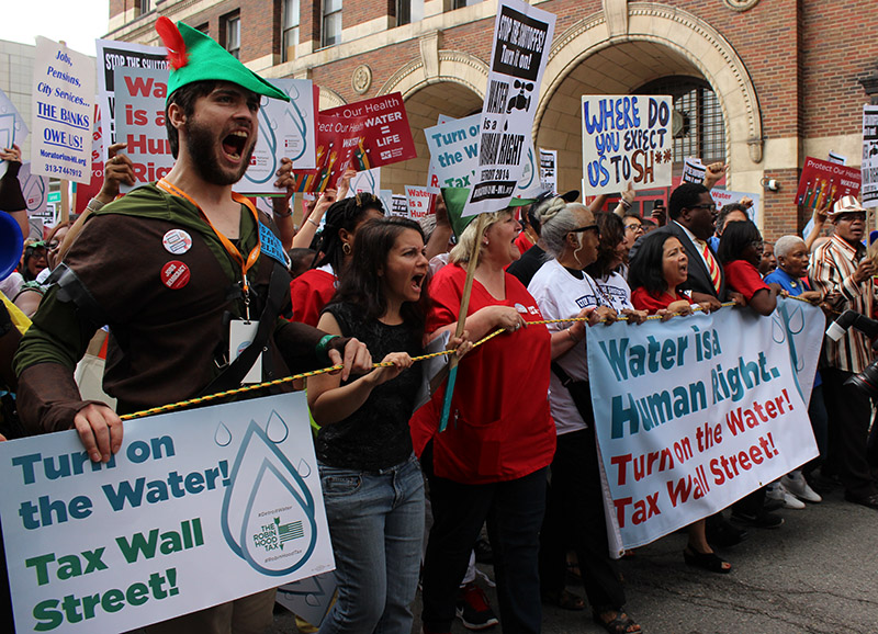 Demonstrators flood the streets of Detroit to protest the city shutting off water to over 15,000 residents this year.