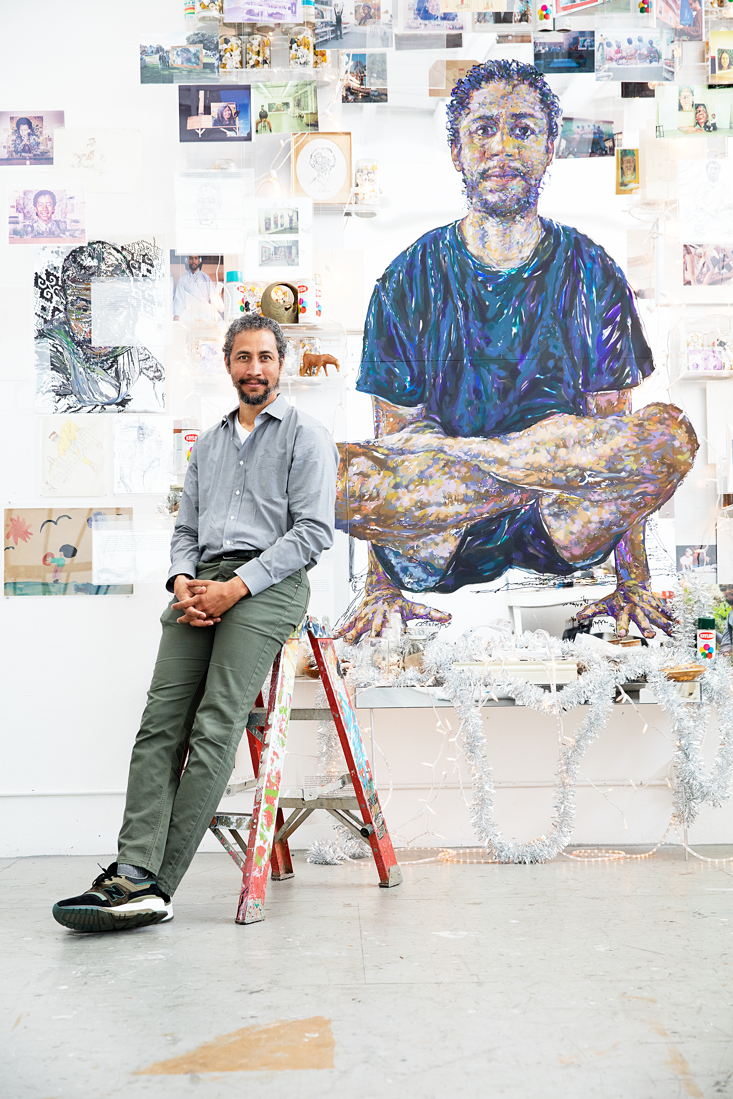 Artist Brett Cook is shown in front of one of his self-portraits