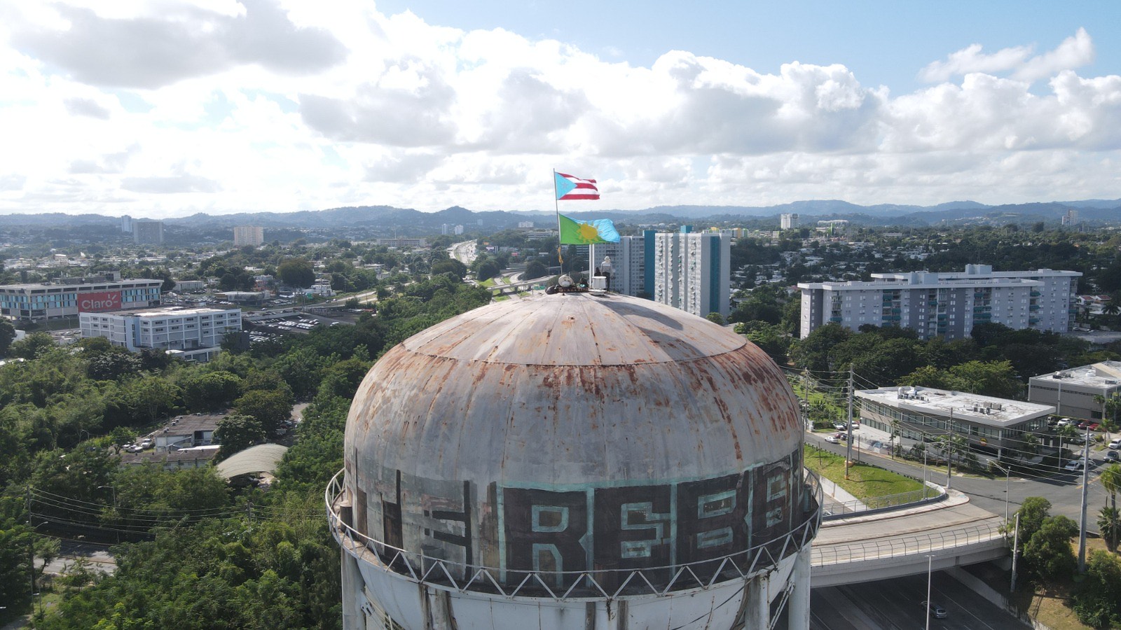 Casa Pueblo flag flying in San Juan, atop a water tower at the former Oso Blanco Prison.