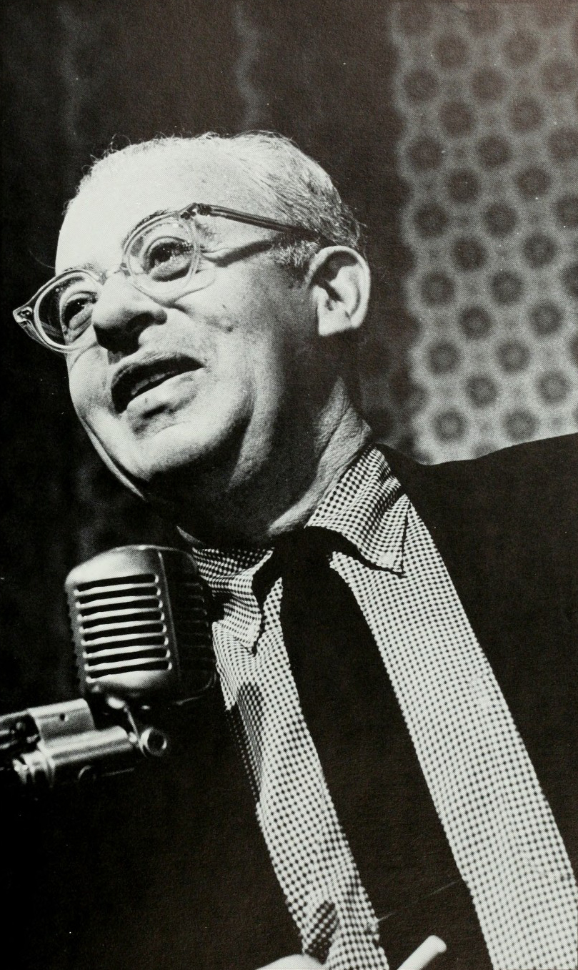 Saul Alinsky speaking into a microphone