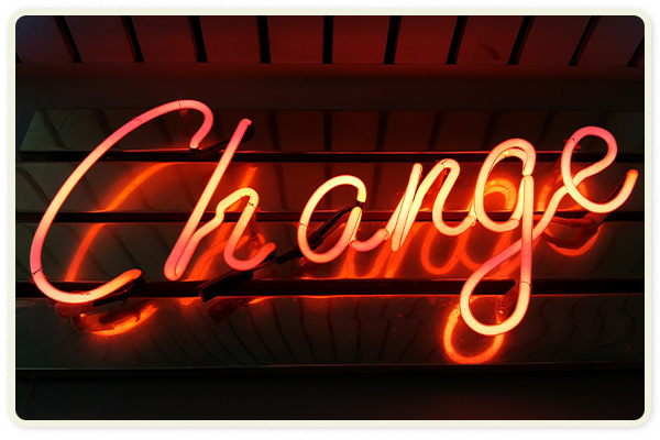 A red neon sign says "Change"