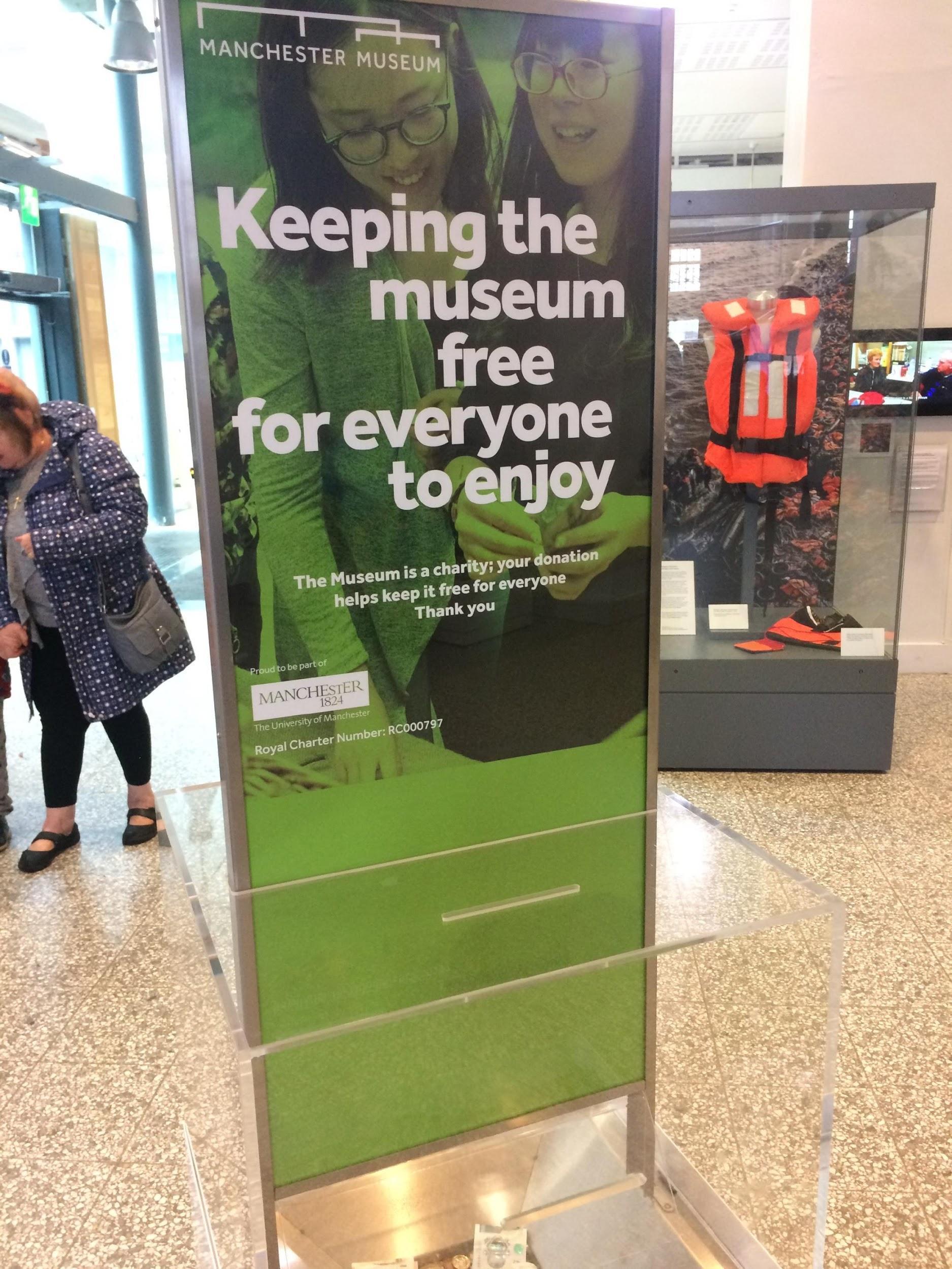 A museum placard reads "Keeping the museum free for everyone to enjoy."