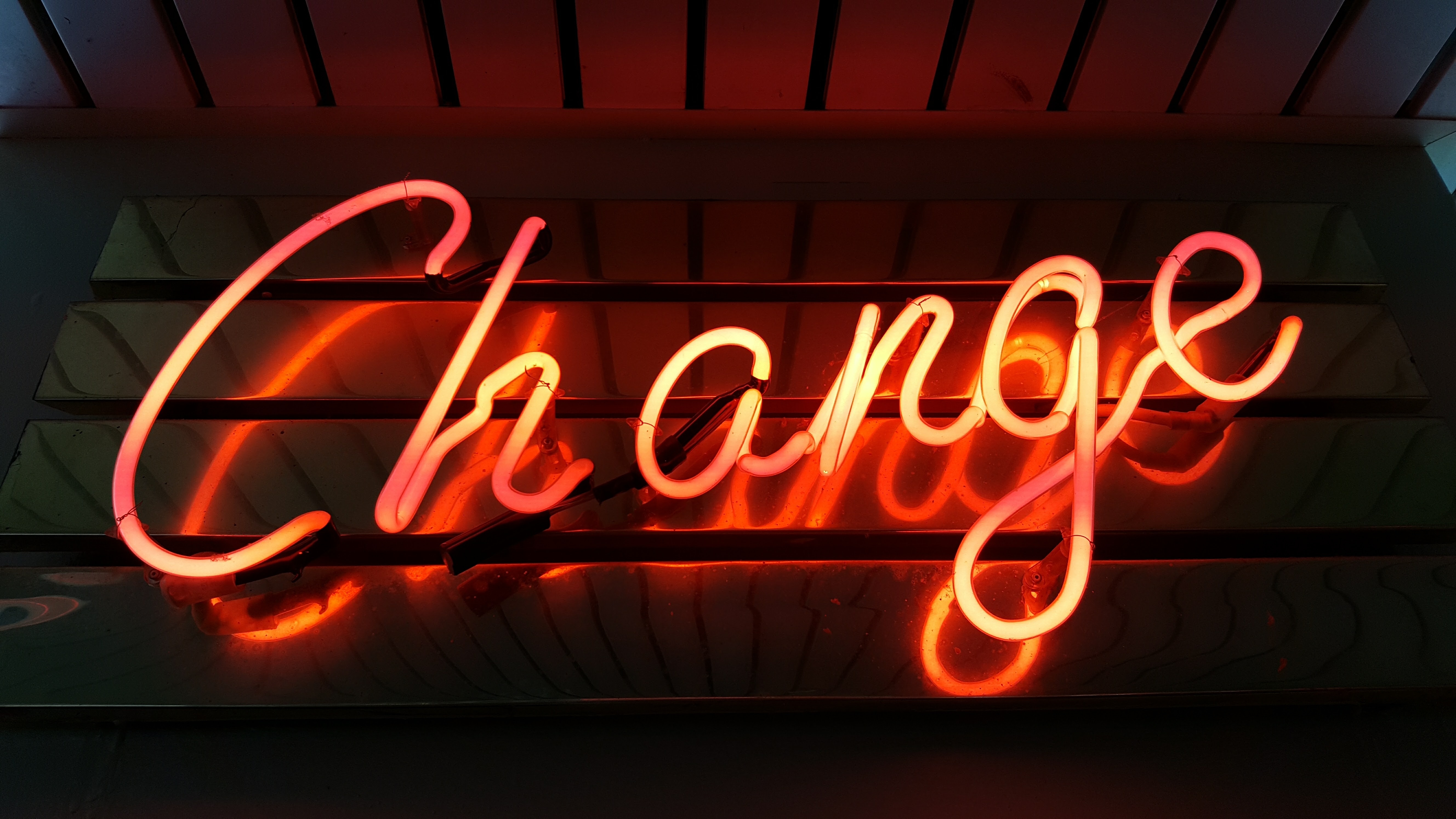 A red neon sign reads "Change"