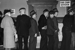 This image is Applicants for food stamps line up before a window in the Food Stamp Division Office in Rochester, New York, the first city the Federal Food Stamp Plan in 1939. Photo Courtesy National Archives and Records Administration.