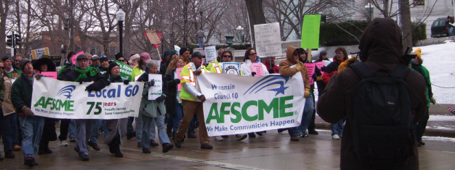 This image is of protestors holding signs titled "AFSCME - We make community happen" 