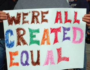 This image is of a sign that reads "We're all created equal" 