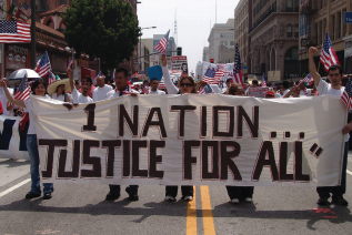 This image is of protestors holding a sign titled "1 nation justice for all "