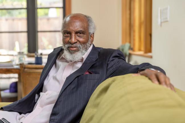 john seated on his couch