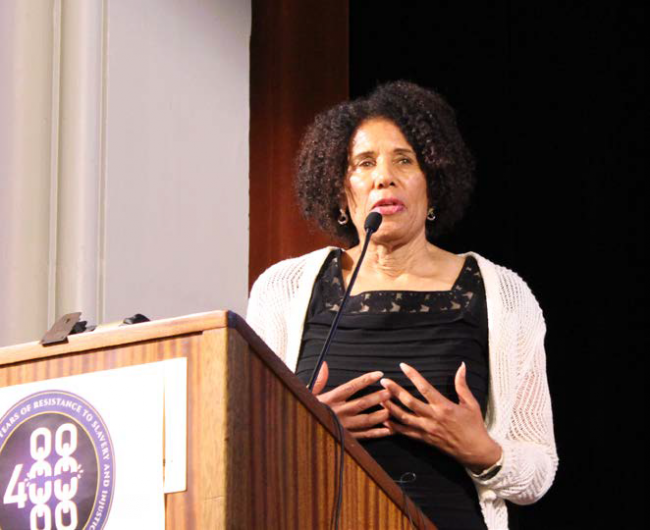 Denise Herd speaking at a podium