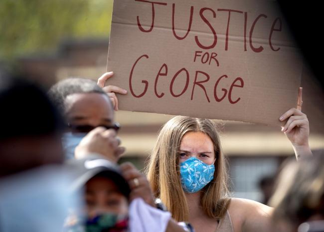 protester holding sign that reads Justice for George