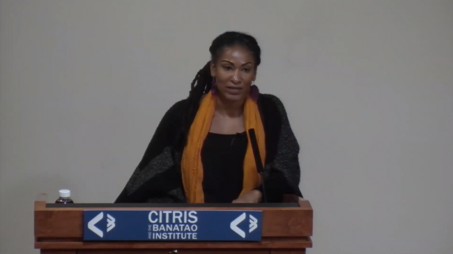 Ruha Benjamin speaking at podium